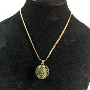Jade Buddha pendant on gold tone metal Necklace